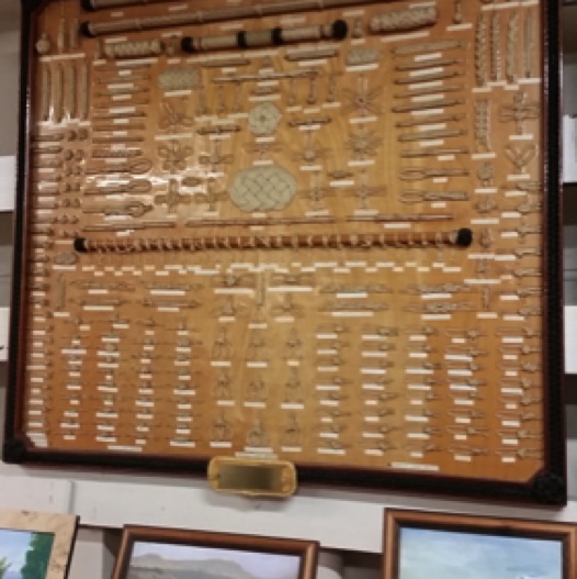 A knot board and local art are displayed in the ship's museum.